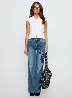 front view of model wearing Princess Polly Sisterhood Mid Rise Wide Leg Patchwork Jeans Mid Blue Wash Mid Rise Jeans 