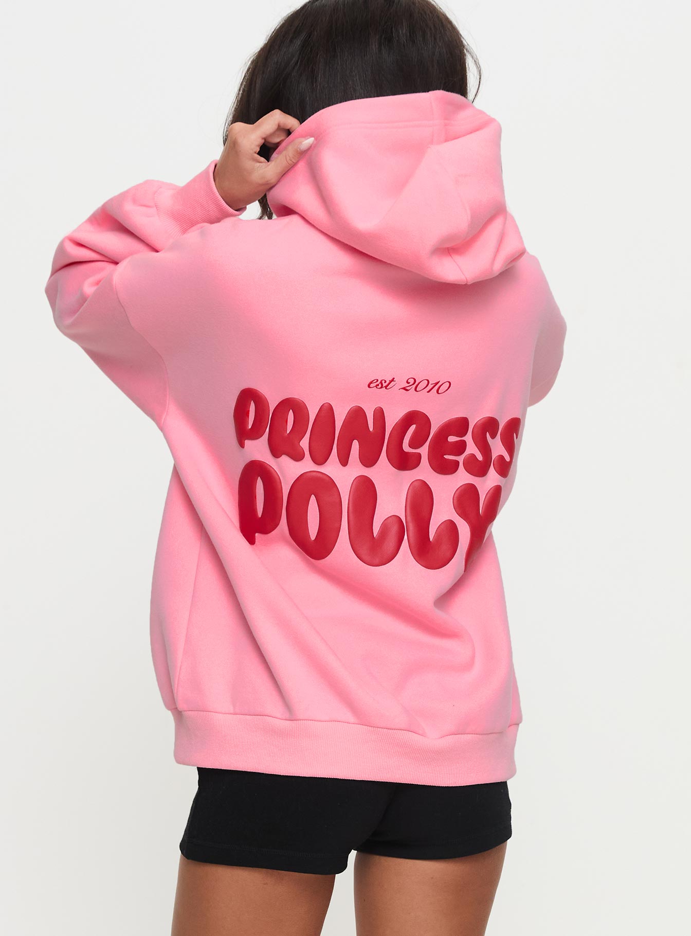 back view of model wearing Princess Polly Princess Polly Hooded Sweatshirt Bubble Text Pink / Red Long 