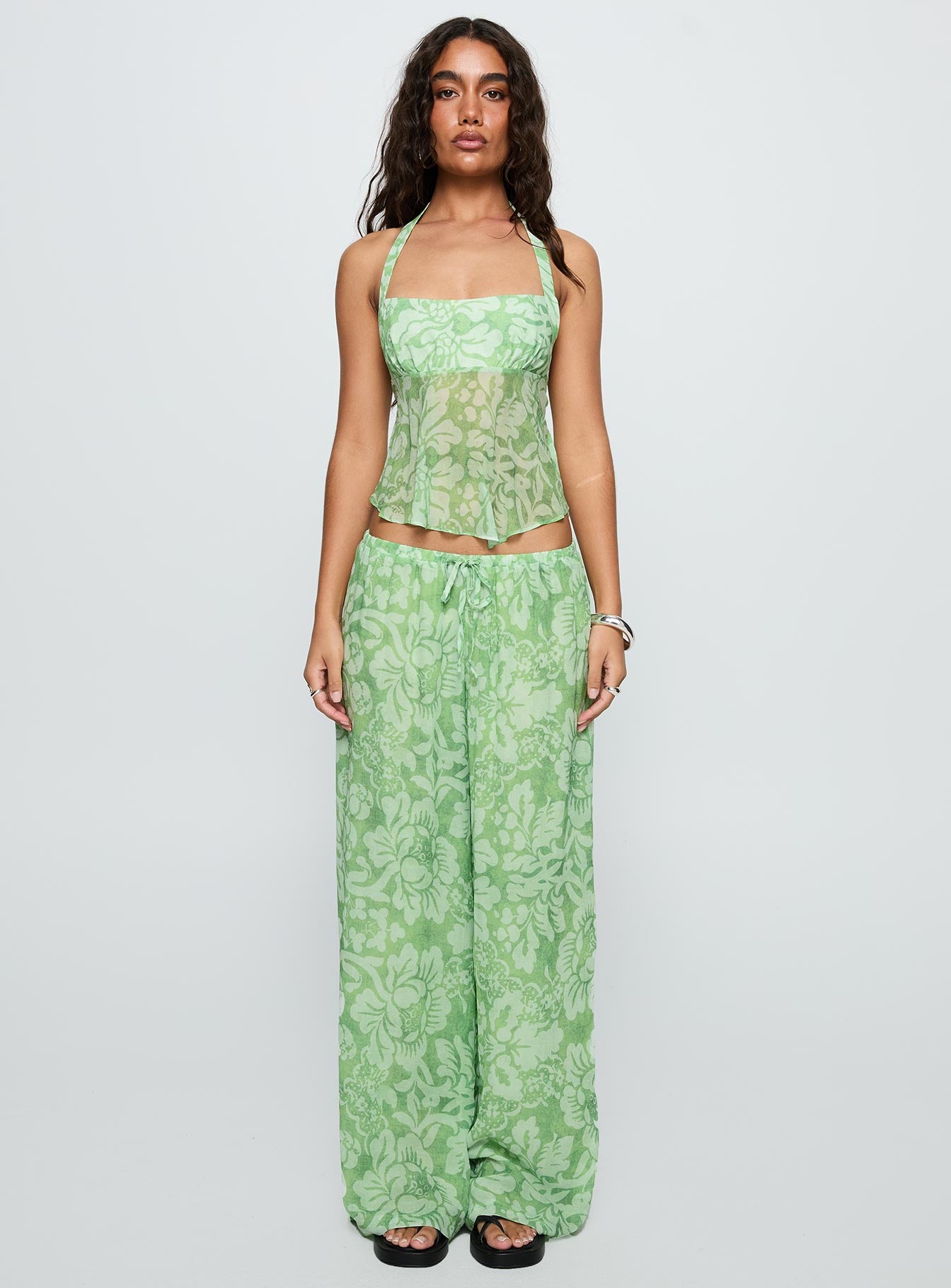 front view of model wearing Princess Polly Finesse Halter Top Green Floral Sleeveless Square Neck 