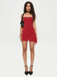 Red Strapless mini dress inner silicone strap at bust, tie fastening detail, ruching at side, asymmetric hem