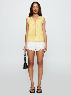 front view of model wearing Princess Polly Angourie Blouse Top Lemon Sleeveless Crew Neck 