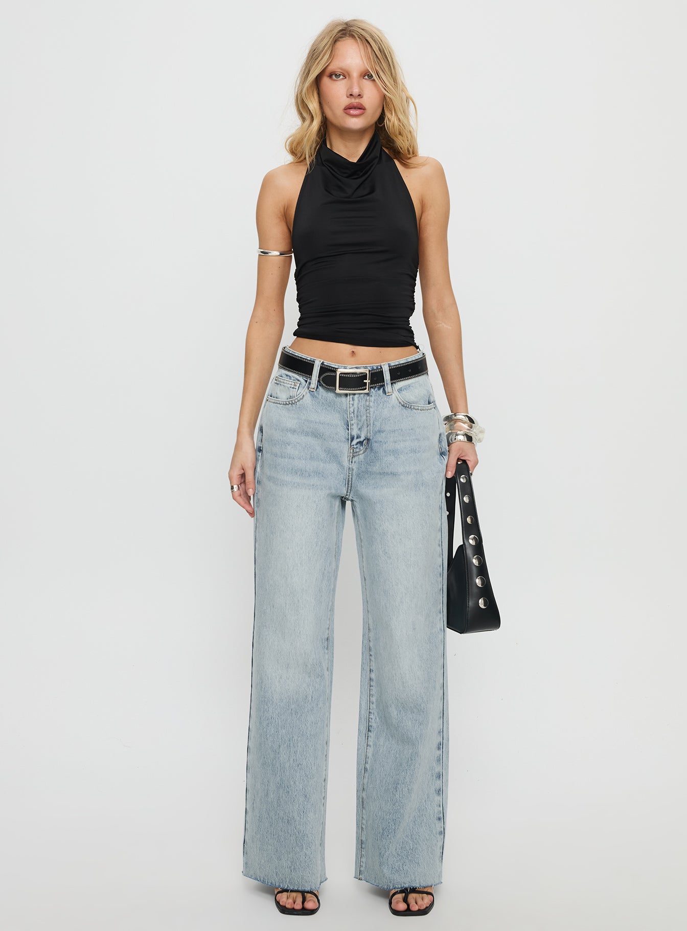 side view of model wearing Princess Polly Henesey High Rise Straight Leg Jeans Light Wash Mid Rise Jeans 