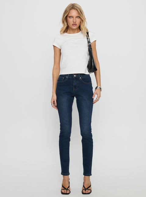front view of model wearing Princess Polly Illyssa Mid Rise Skinny Jeans Mid Blue Wash Mid Rise Jeans 