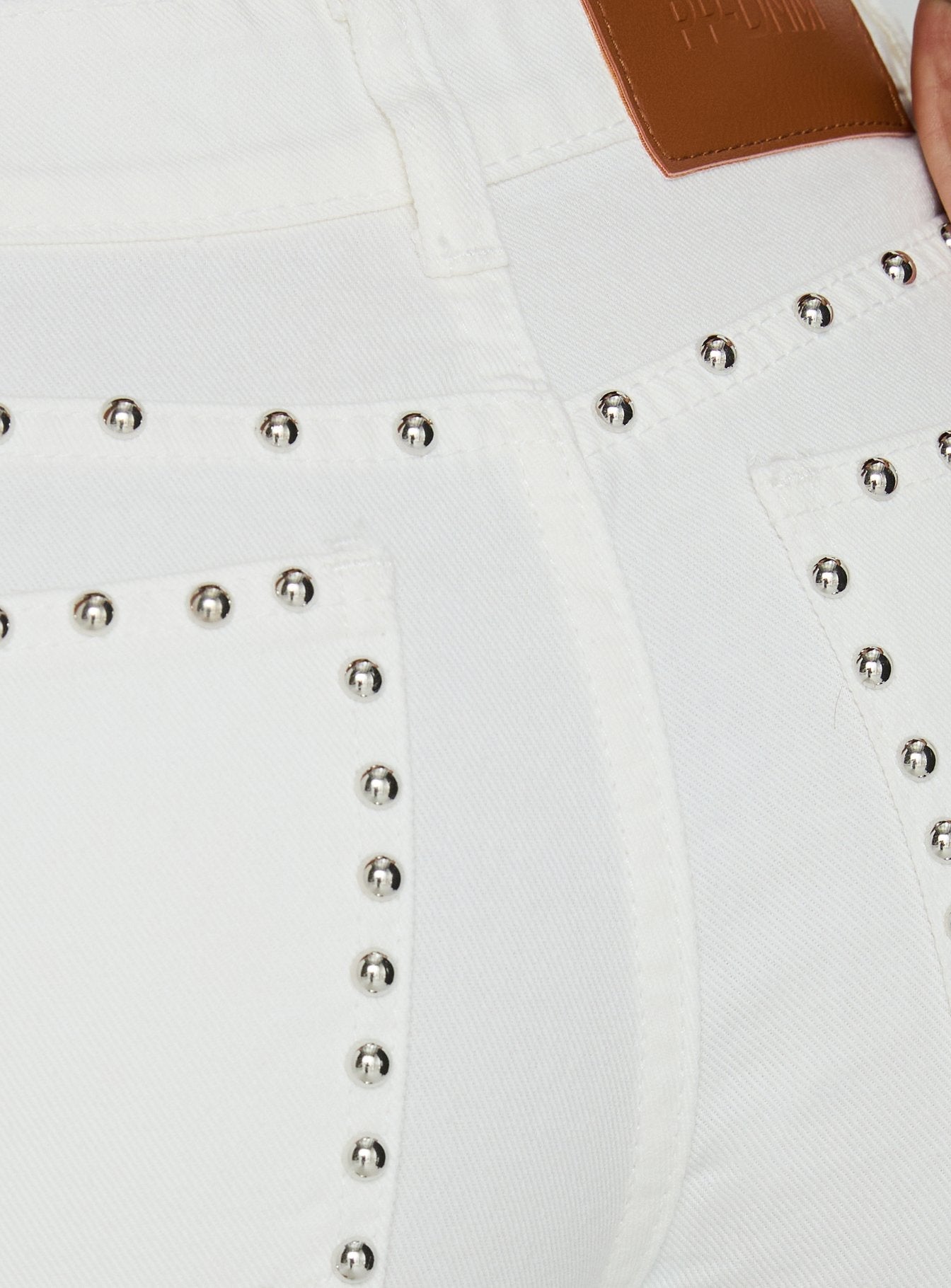Highlighting the Saving Up Mid Rise Straight Leg Studded Jeans White in womens-jeans with silver stud button and belt closure Princess Polly