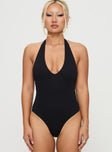 front view of model wearing Princess Polly Someone New Halter Bodysuit Black Tall Sleeveless 