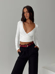 front view of model wearing Princess Polly Cushien Long Sleeve Top White Full Sleeves Plunger 