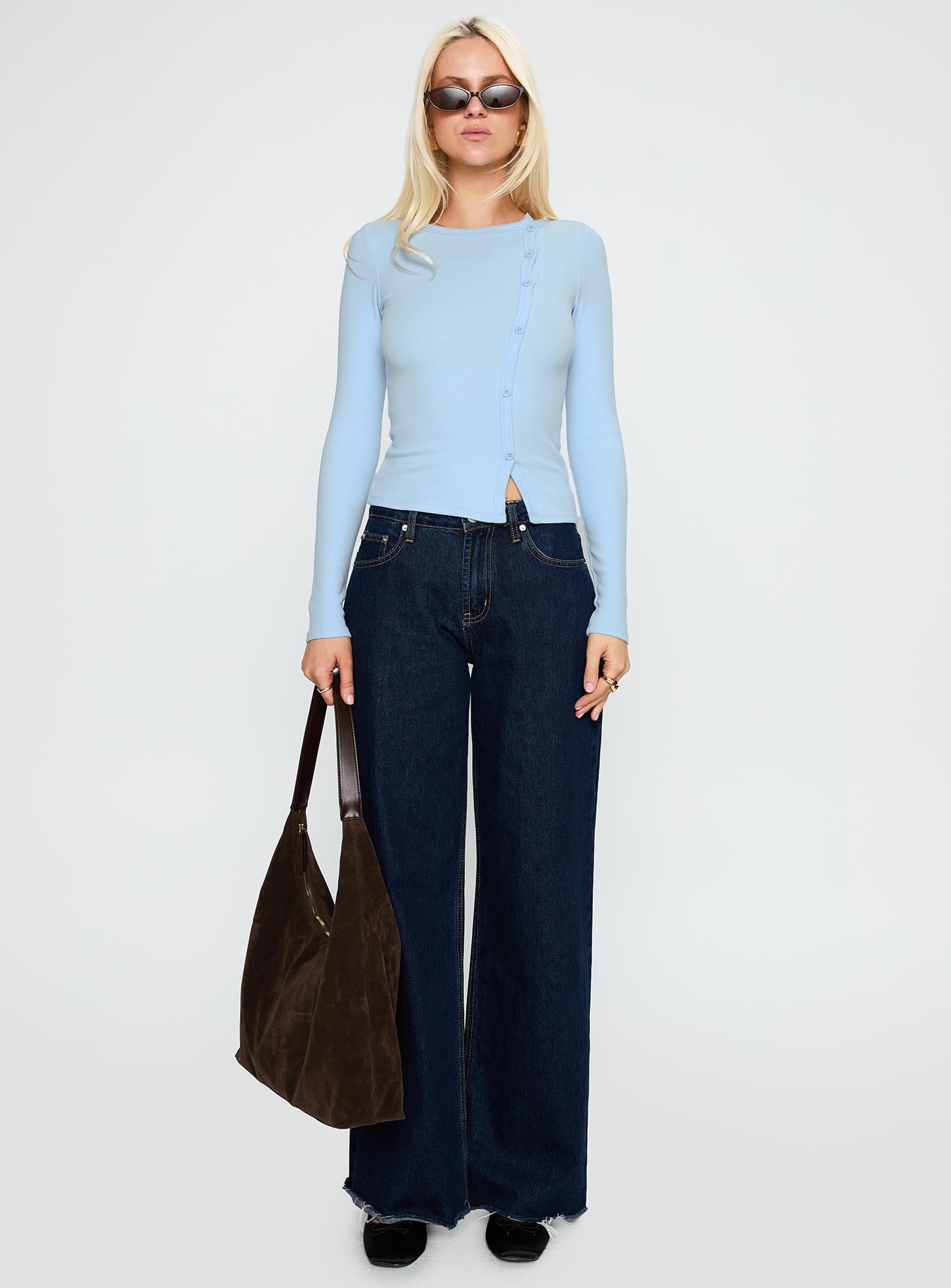 side view of model wearing Princess Polly Passoni Long Sleeve Top Blue Full Sleeves Crew Neck 