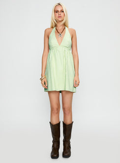 side view of model wearing Princess Polly Estefani Halter Mini Dress Green Stripe Plunger 