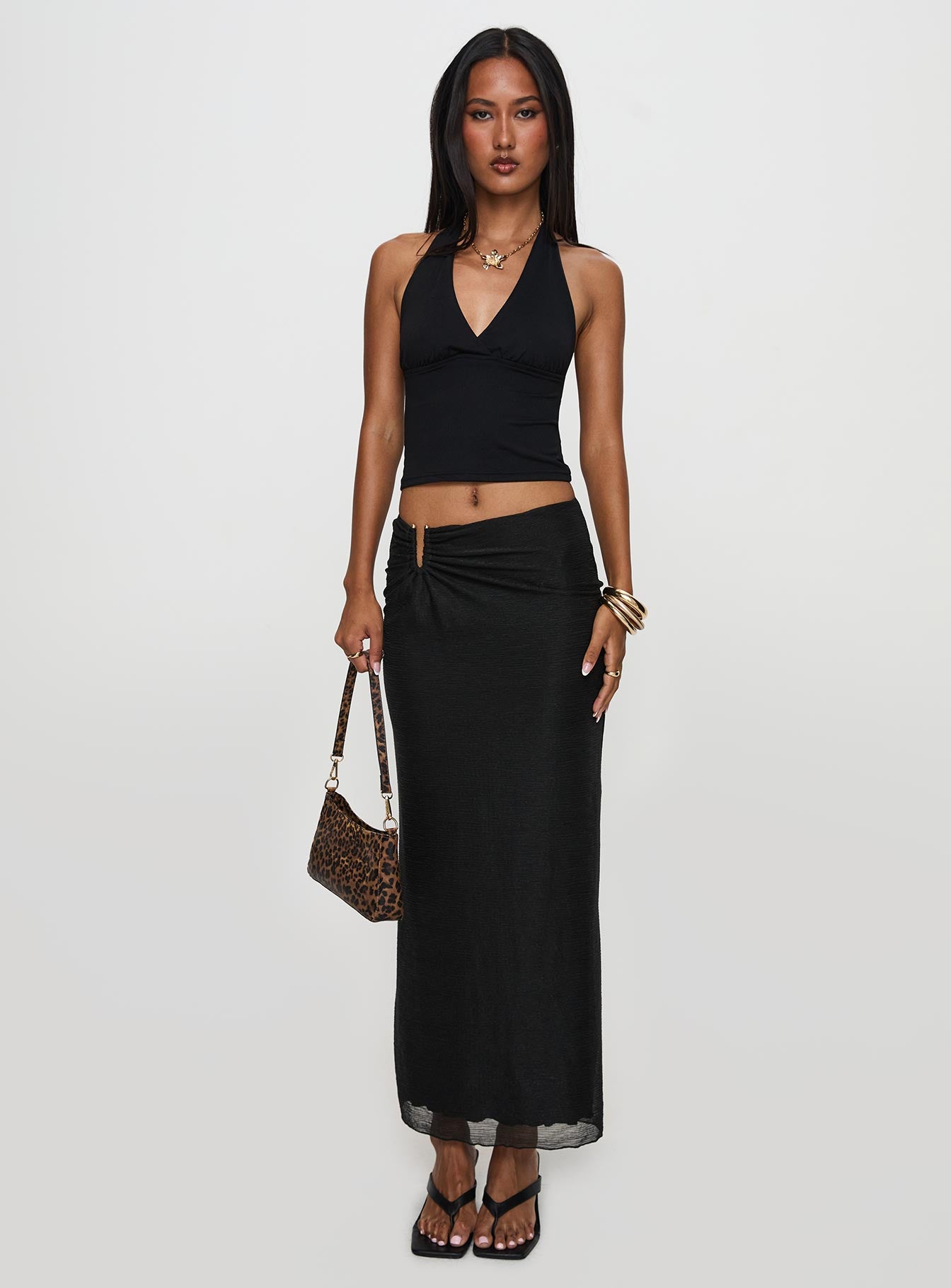   side view of model wearing Princess Polly Satine Maxi Skirt Black Maxi 