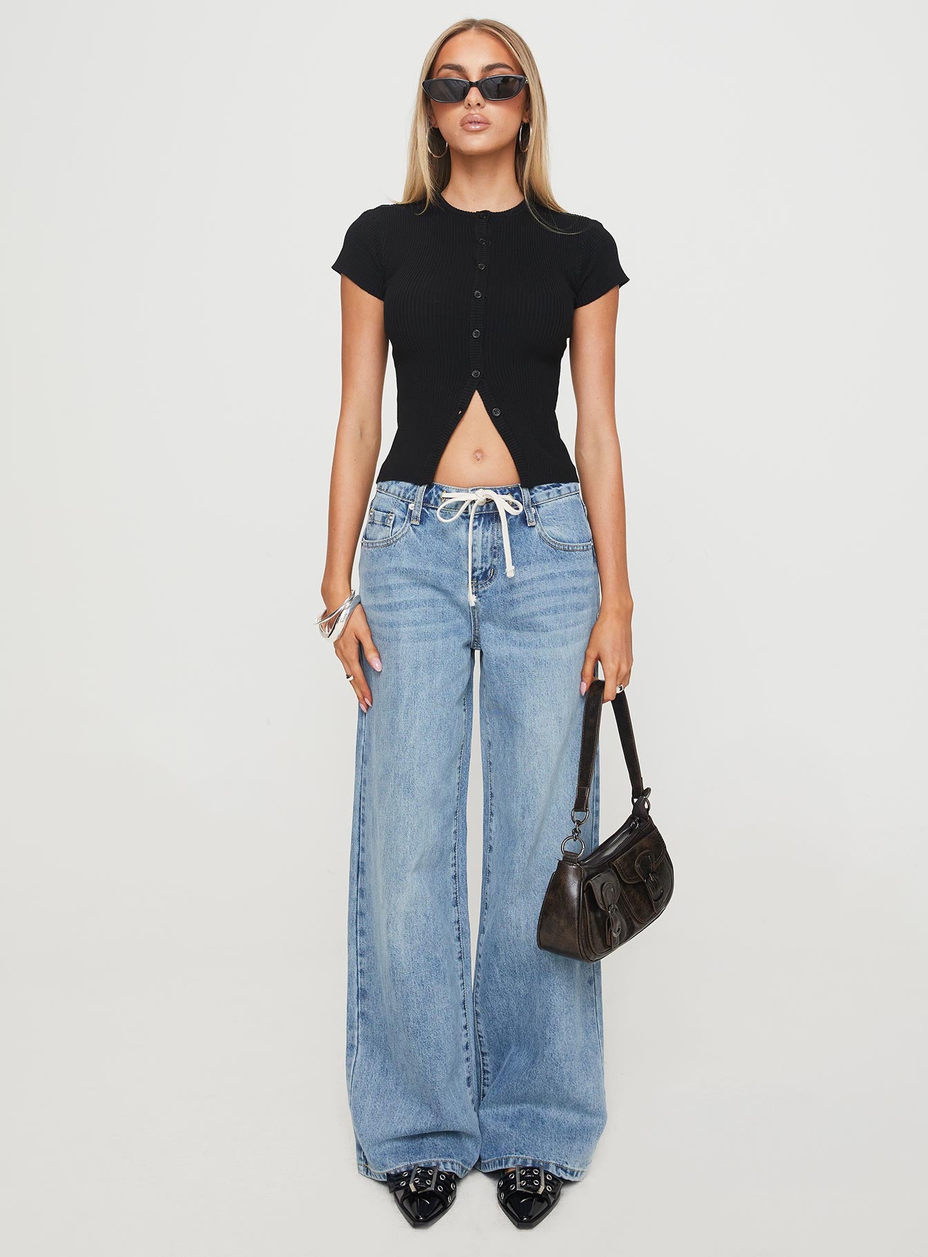 side view of model wearing Princess Polly Suzu Top Black Short Sleeves High Neck 