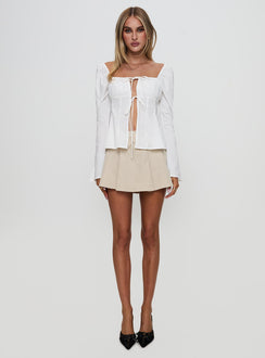 side view of model wearing Princess Polly Lilibette Tie Up Long Sleeve Top White Full Sleeves Square Neck 