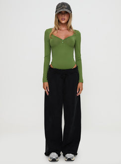 side view of model wearing Princess Polly Delgado Long Sleeve Bodysuit Olive Full Sleeves 