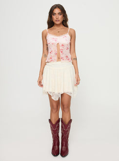 side view of model wearing Princess Polly Emrys Top Beige / Red Floral Sleeveless Scoop Neck 