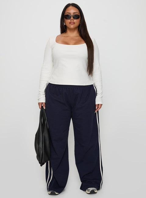 front view of model wearing Princess Polly Circuit Track Pants Navy Curve 