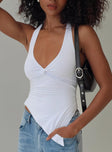 front view of model wearing Princess Polly Chilli Halter Top White Sleeveless Plunger 