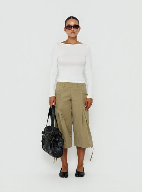 Showcasing the Iria Capri Trouser Khaki womens-regular-pants with mid-rise waist front view of model wearing Princess Polly