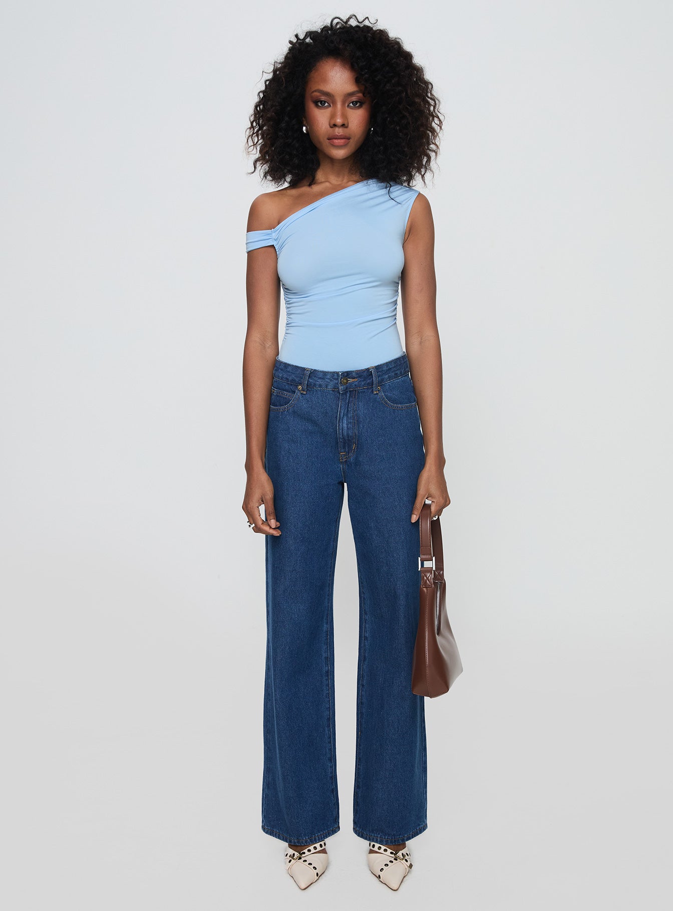 side view of model wearing Princess Polly Beller Bodysuit Blue Sleeveless Asymmetric Neckline 