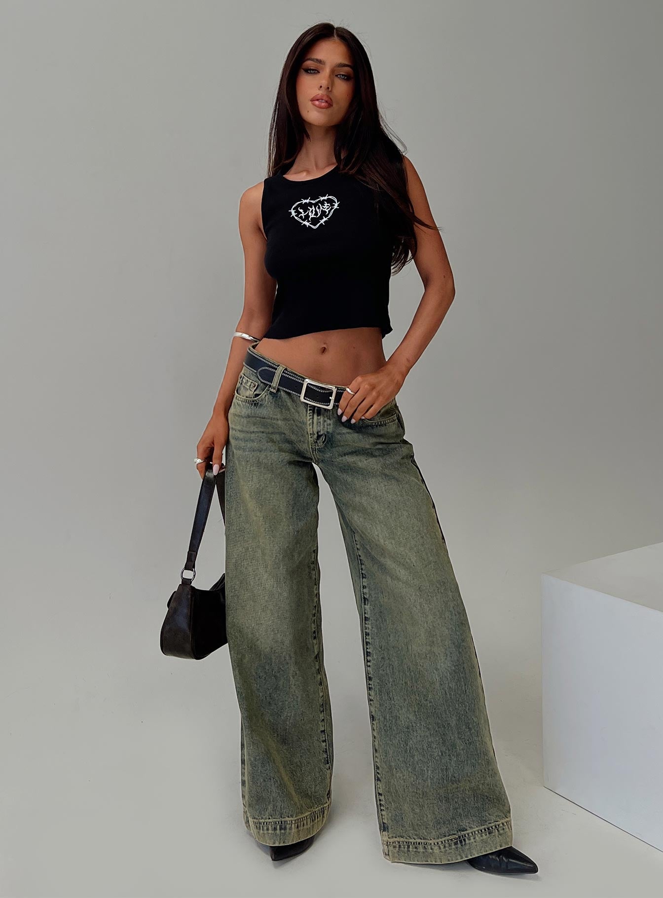 side view of model wearing Princess Polly Radiantia Tank Top Black Sleeveless Crew Neck 