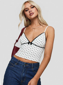 side view of model wearing Princess Polly Rune Top White / Black Sleeveless Plunger 