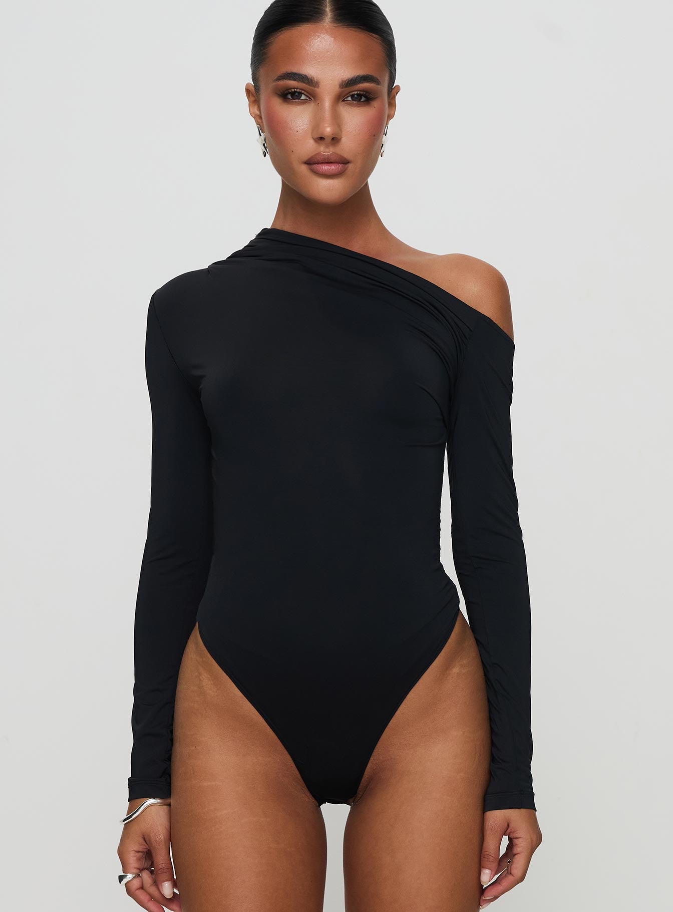 front view of model wearing Princess Polly Antilles One Shoulder Bodysuit Black Full Sleeves 