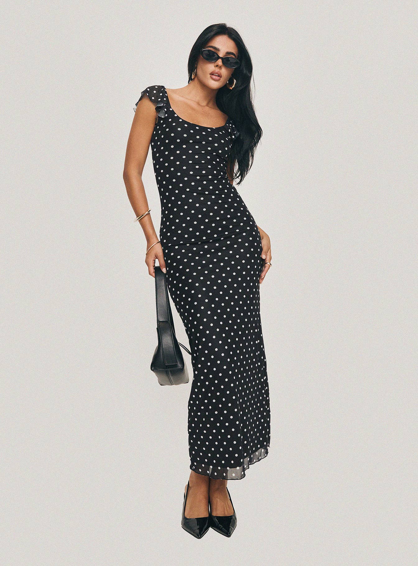 side view of model wearing Princess Polly Sandberg Maxi Dress Black Polka Dot Scoop Neck 