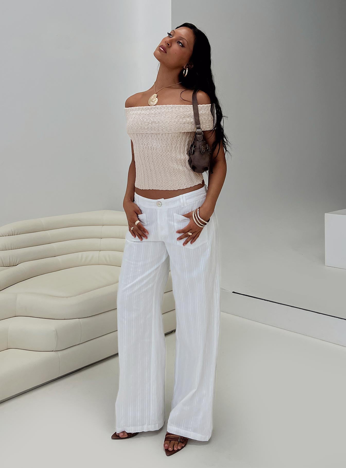 side view of model wearing Princess Polly Vendi Low Rise Pant White Petite Low Rise Pants 