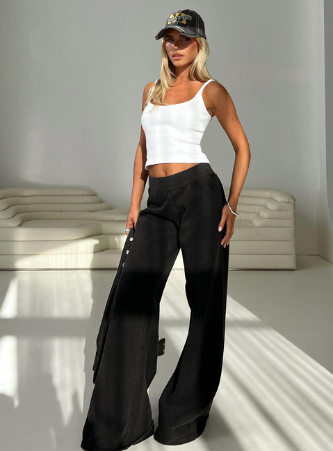 side view of model wearing Princess Polly Summits Flared Track Pants Washed Black High Waisted Pants 
