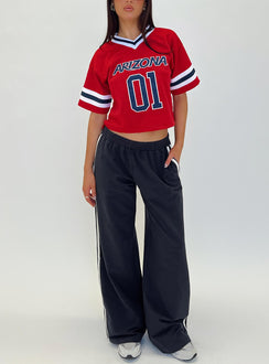 front view of model wearing Princess Polly U of A Football Jersey Red Half Sleeves V-Neck 