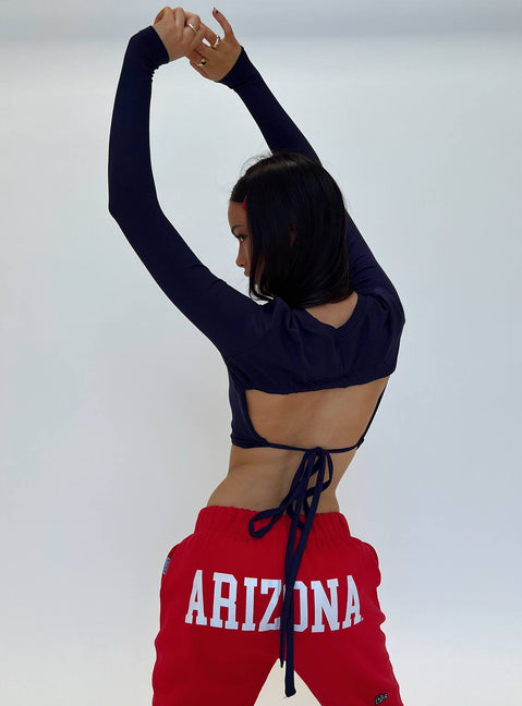 back view of model wearing Princess Polly U of A Bring It Back Long Sleeve Top Navy Full Sleeves Crew Neck 