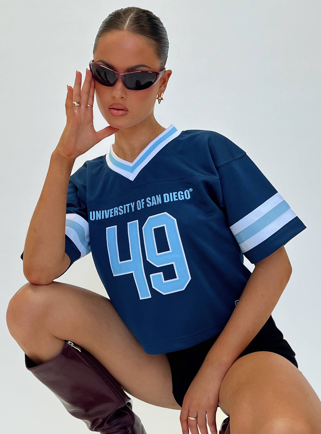 front view of model wearing Princess Polly USD Football Jersey Navy Half Sleeves V-Neck 