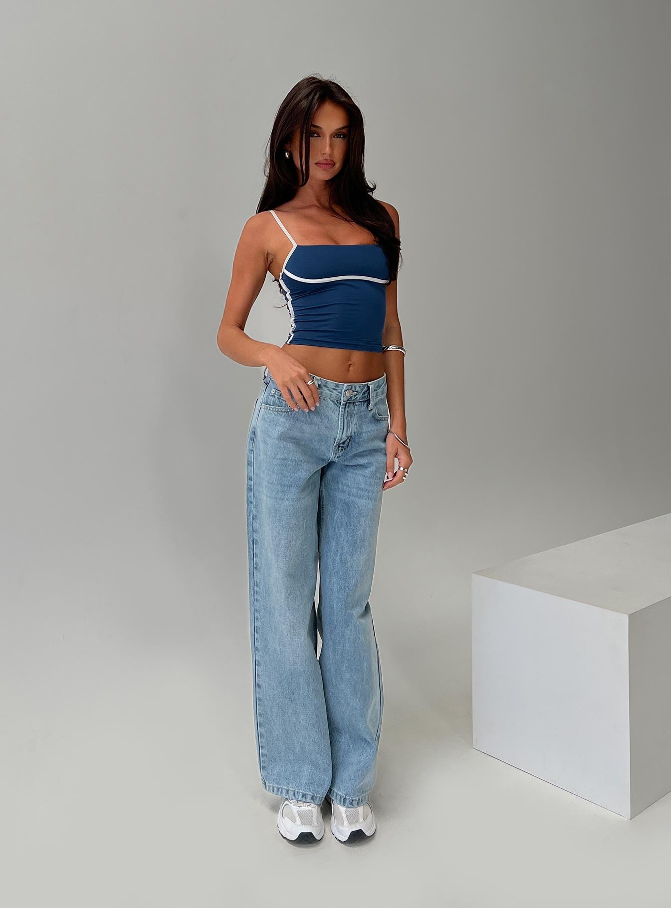 side view of model wearing Princess Polly Serenitia Mid Rise Relaxed Jeans Light Wash Petite Mid Rise 