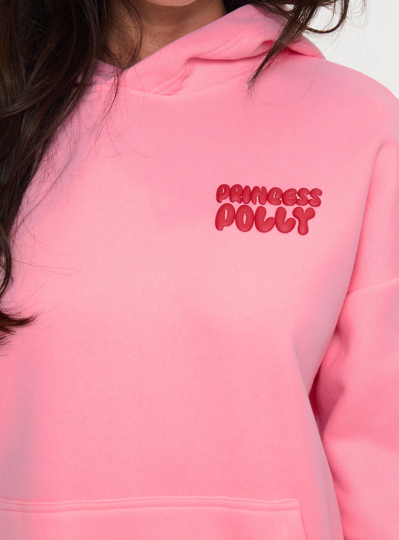 side view of model wearing Princess Polly Princess Polly Hooded Sweatshirt Bubble Text Pink / Red Long 