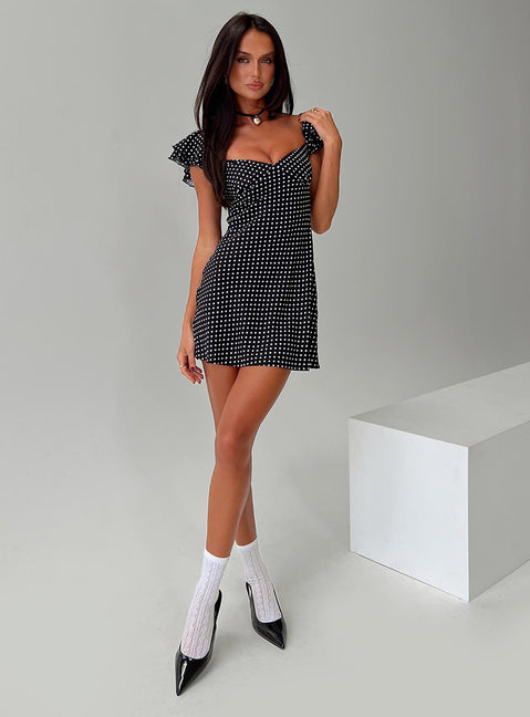 side view of model wearing Princess Polly Moretti Mini Dress Black Polka Dot Sweetheart Neckline 