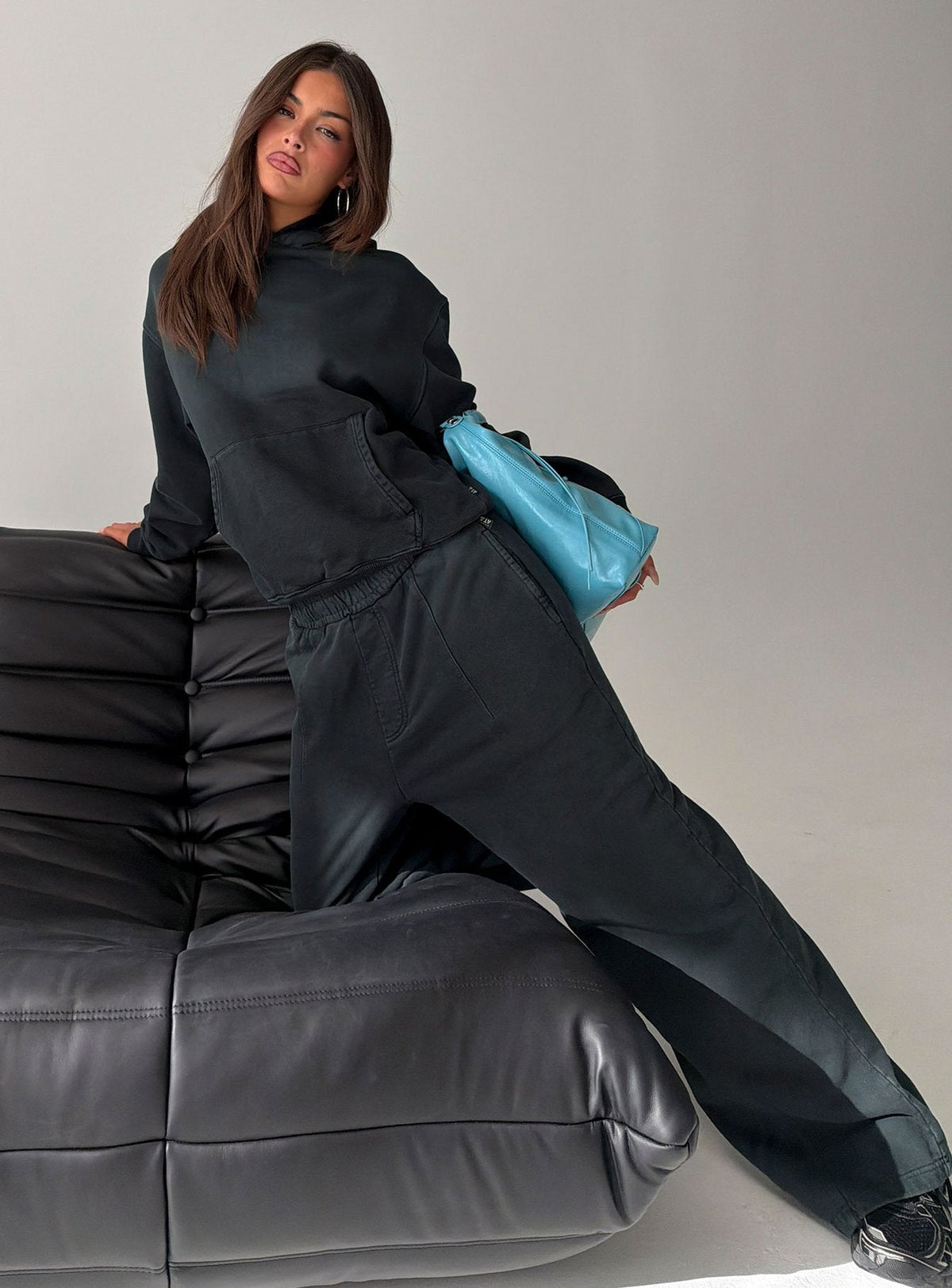 Showcasing black Baggy Sweatpant in womens regular pants with wide-leg mid-rise silhouette side view of model wearing Princess Polly