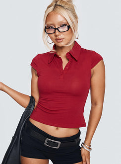 side view of model wearing Princess Polly Prodigy Collared Polo Top Red Short Sleeves V-Neck 