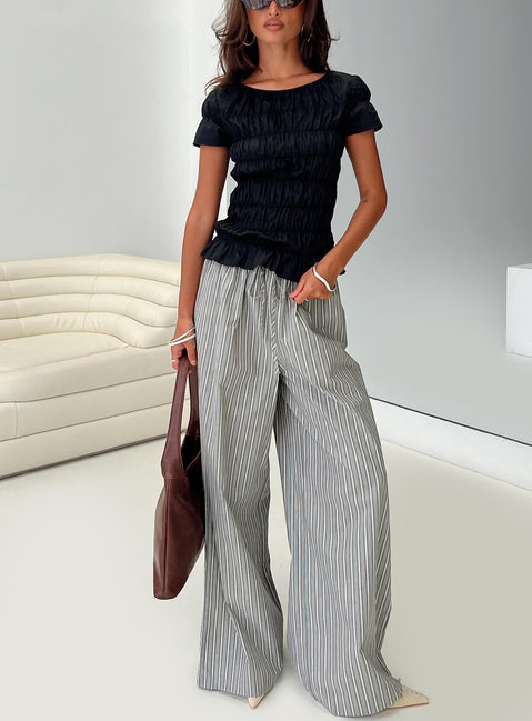 front view of model wearing Princess Polly Spoiler Alert Ruched Top Black Short Sleeves Scoop Neck 