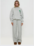 side view of model wearing Princess Polly Princess Polly Wide Leg Track Pant Bubble Text Grey Marle / Green 