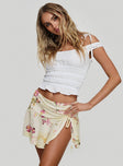   side view of model wearing Princess Polly Sassie Mini Skirt Floral Mini Skirts 