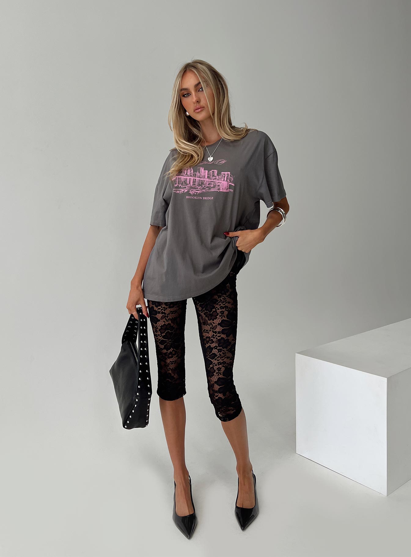 side view of model wearing Princess Polly Brooklyn Bridge Tee Black Half Sleeves Crew Neck 