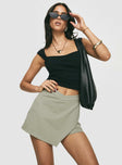 side view of model wearing Princess Polly Maceline Wrap Front Skort Green 