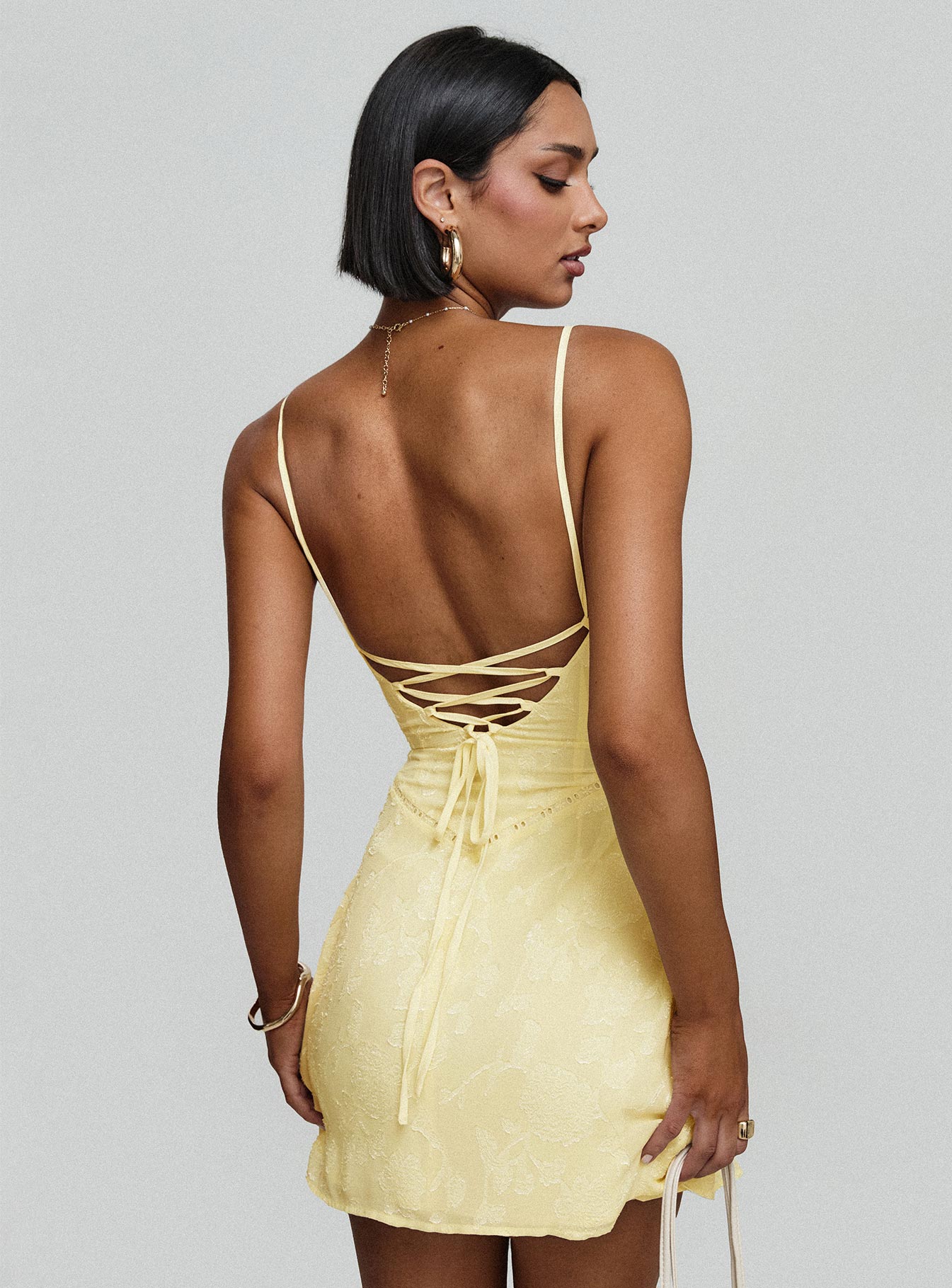 back view of model wearing Princess Polly South Of France Mini Dress Yellow Petite Square Neck 