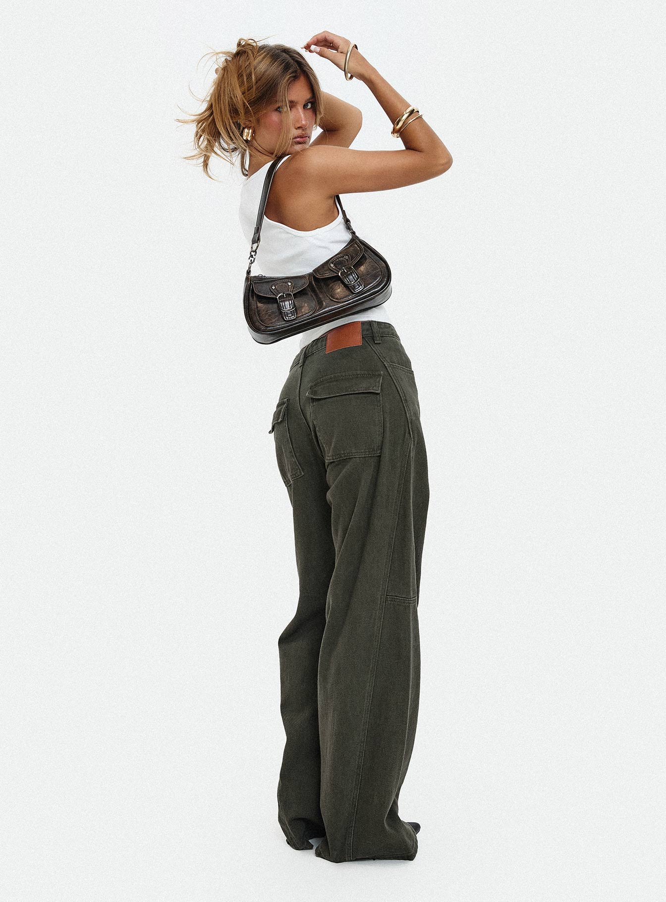 side view of model wearing Princess Polly Bruiser Tie Waist Mid Rise Wide Leg Jeans Green Petite High Rise Jeans 