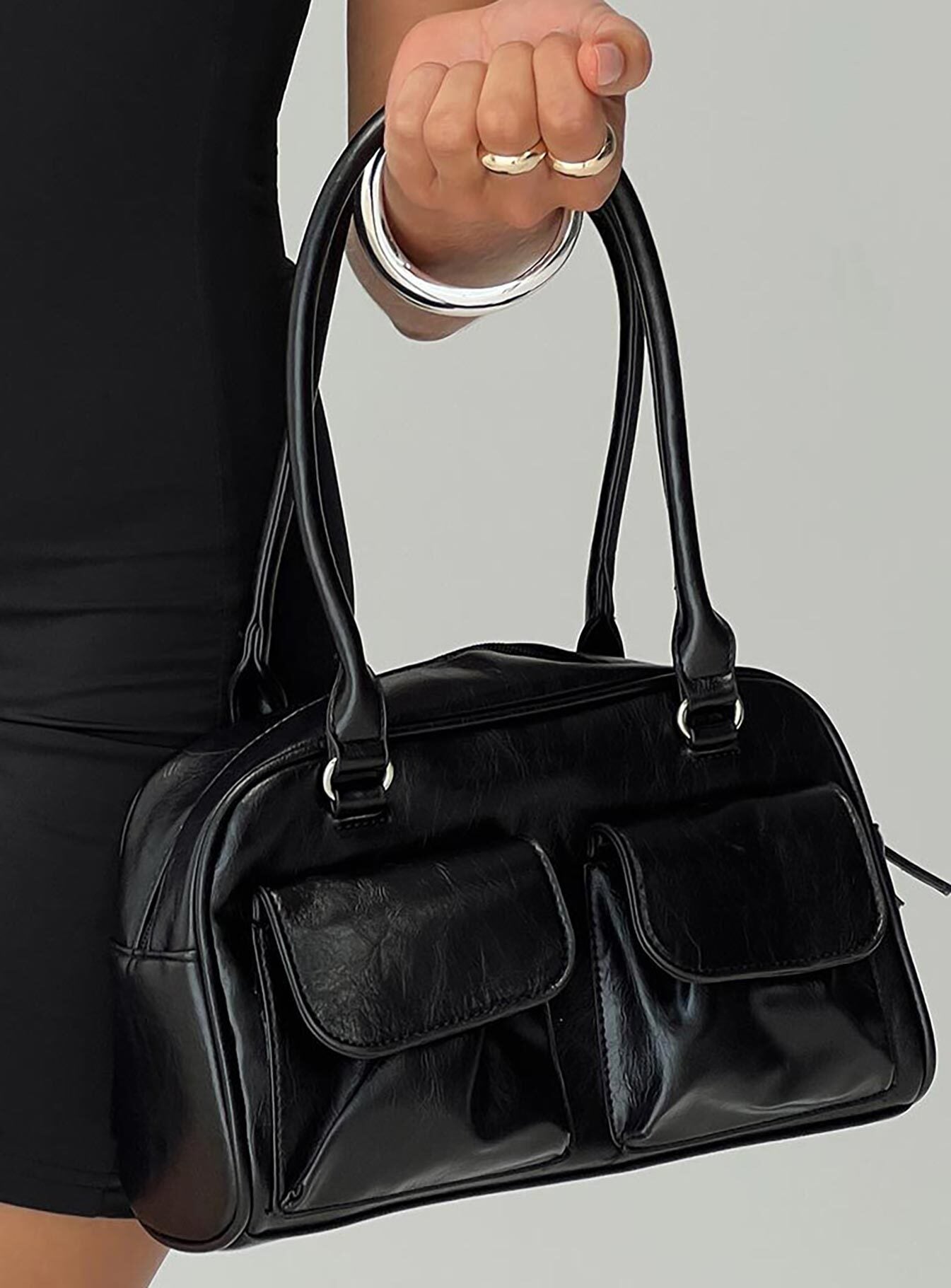 Black bag Silver-toned hardware, zip fastening, twin external pockets with magnetic button fastening, internal zip pocket, flat base