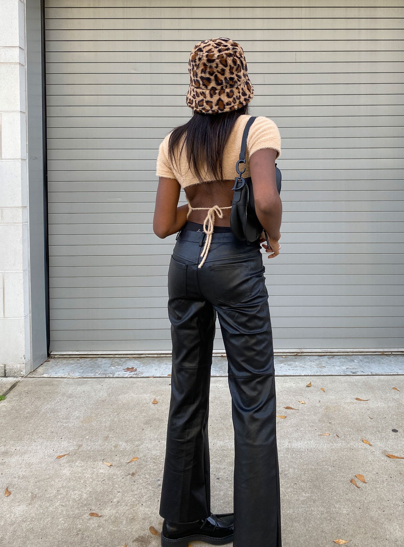 back view of model wearing Princess Polly Macey Pants Black Petite High Waisted Pants 