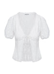 White top tie front fastening lace up fastening at back, puff sleeves, slightly sheer