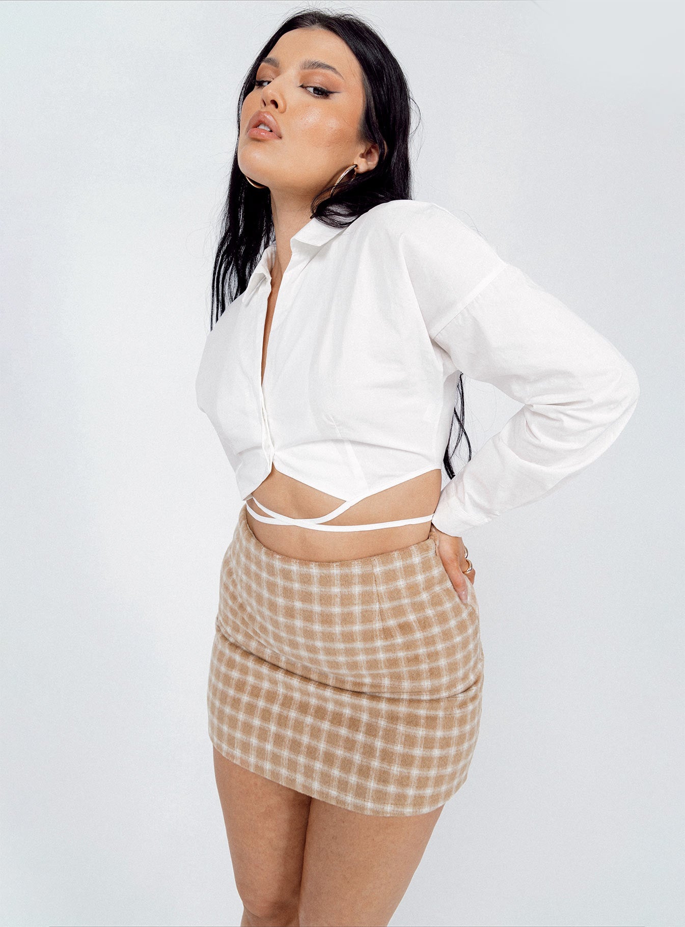   side view of model wearing Princess Polly Gracia Mini Skirt Beige 