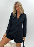 Black blazer Lapel collar  Padded shoulders  Button front fastening  Twin hip pockets 