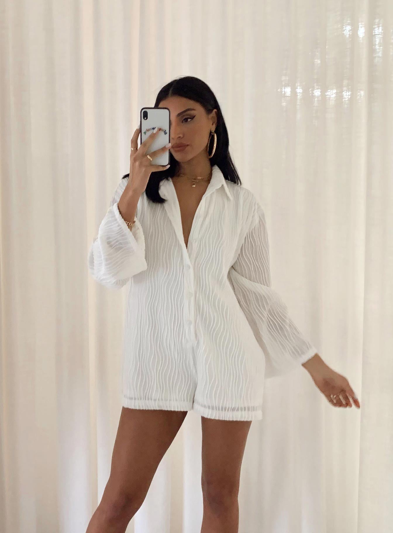 Long sleeve romper Textured material  Button front fastening  Wide sleeves 