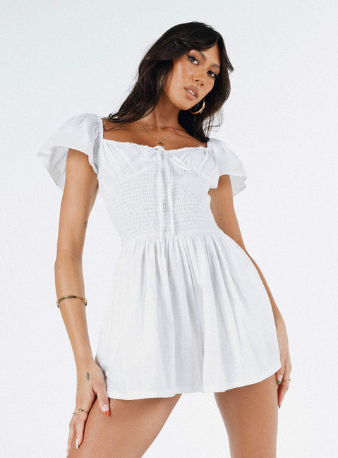 White romper Elasticated shoulders & neckline  Tie at bust  Shirred waist  Twin hip pockets  Fully lined 
