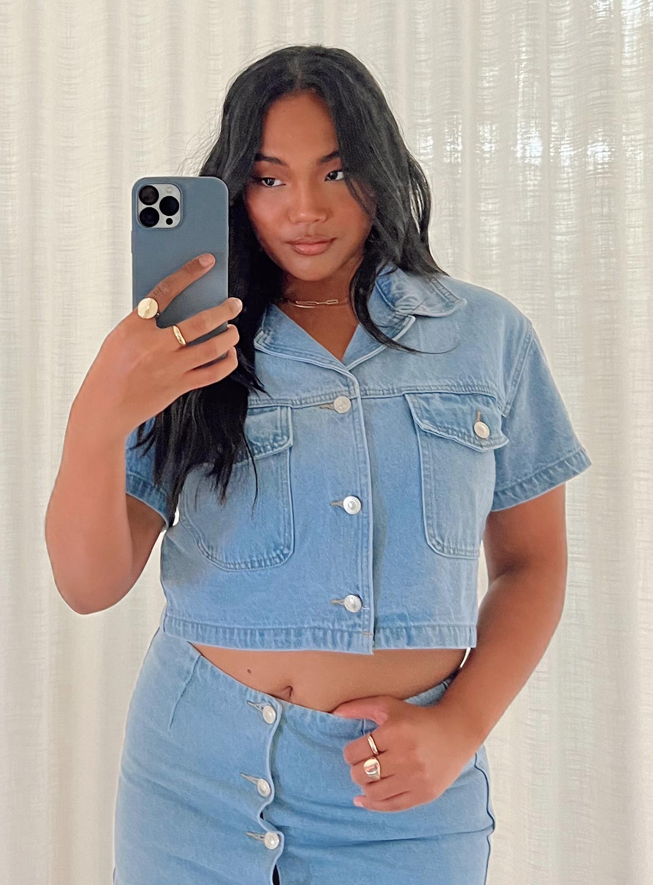 Cropped denim jacket Light wash denim Short sleeves Classic collar Buttons fastening at front Twin chest pockets